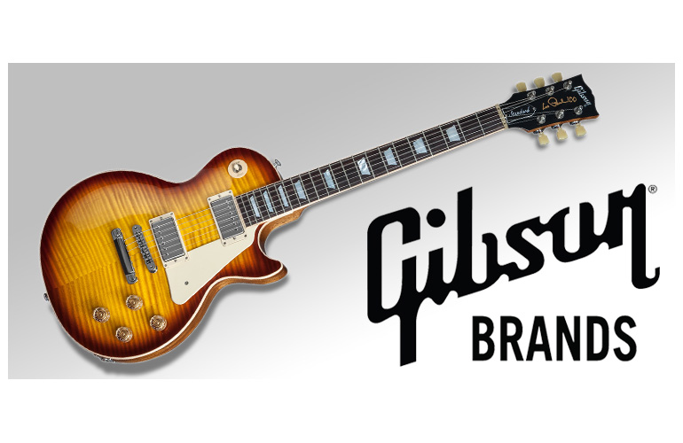A gibson guitar with the brand logo in front of it.