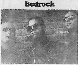 A black and white photo of three people.