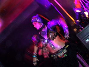 A person in costume is dancing on stage.